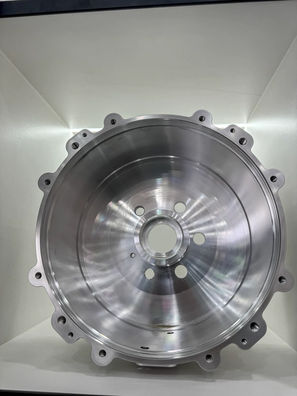 Machined circular housing with a flanged rim